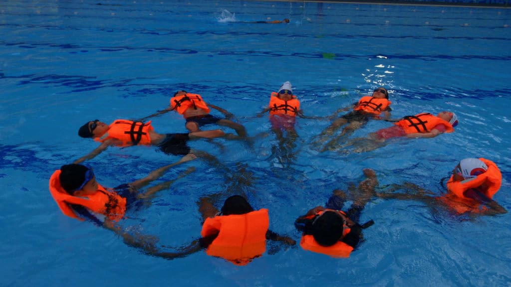 Students Wearing Safe Guard While Learning Swim