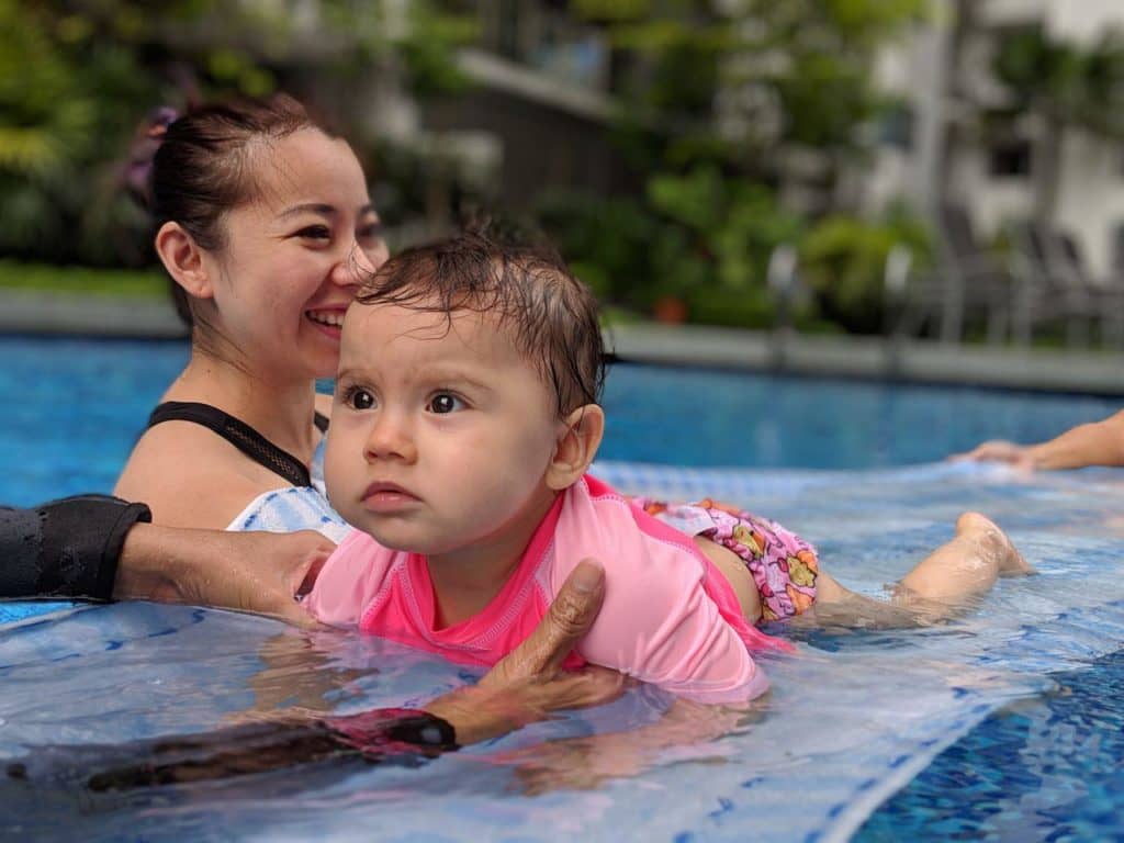 baby learning swimming in pool