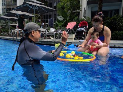 Swimming Coach Teaching Baby 1