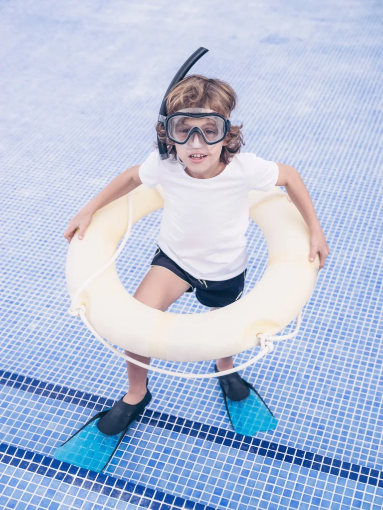 5 Must-Have Qualities of a Great Swimming Instructor 4 medium vecteezy boy with inflatable ring and snorkeling mask in pool 58547404 medium