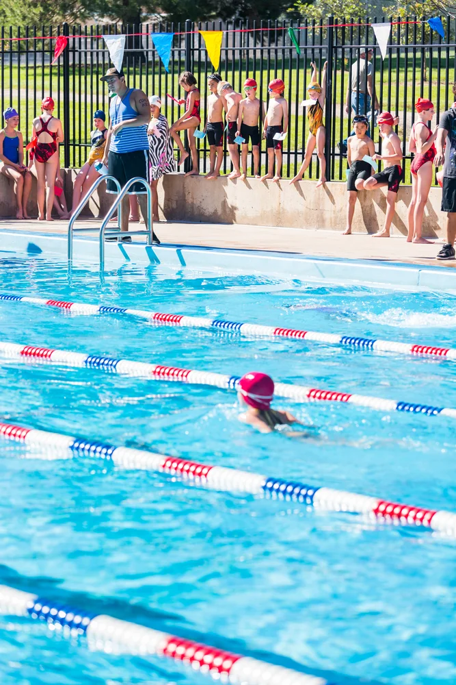 Kids Swim Meet In Outdoor Pool During The Summer
