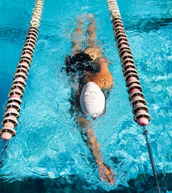 A Person Swimming Freestyle In A Pool, Framed By Lane Lines